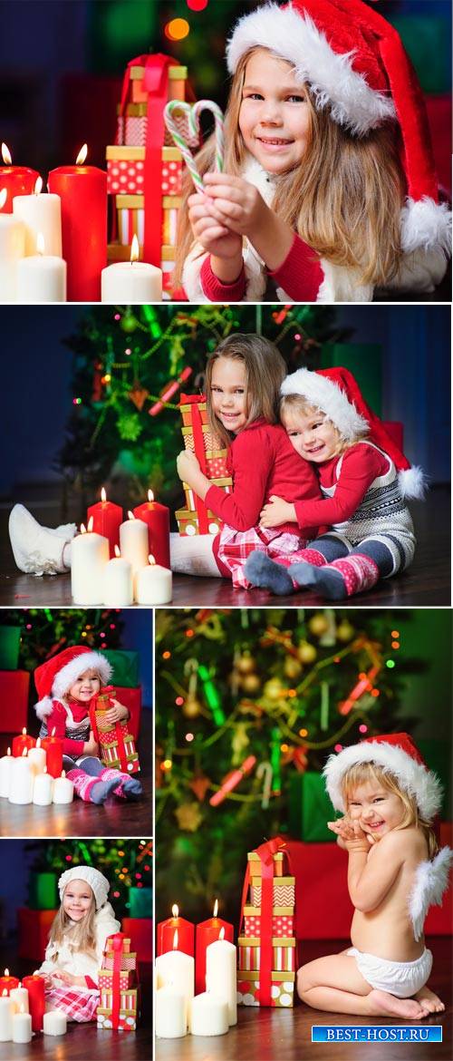 Small children have a Christmas tree - Stock Photo