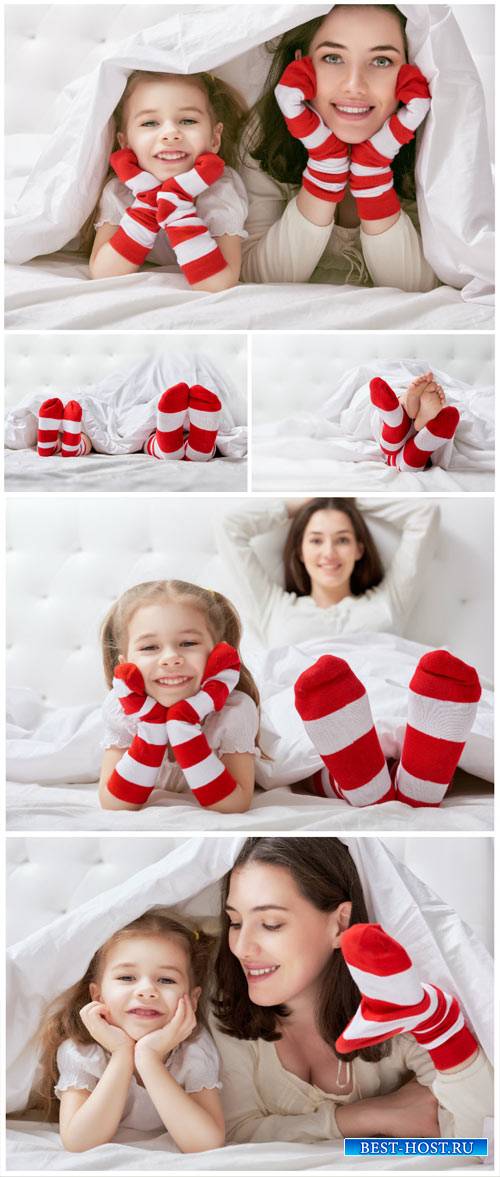 Mother and daughter on the bed - Stock Photo