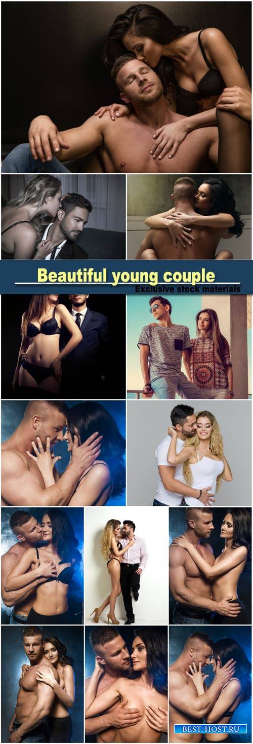 Beautiful young smiling couple in love embracing indoor