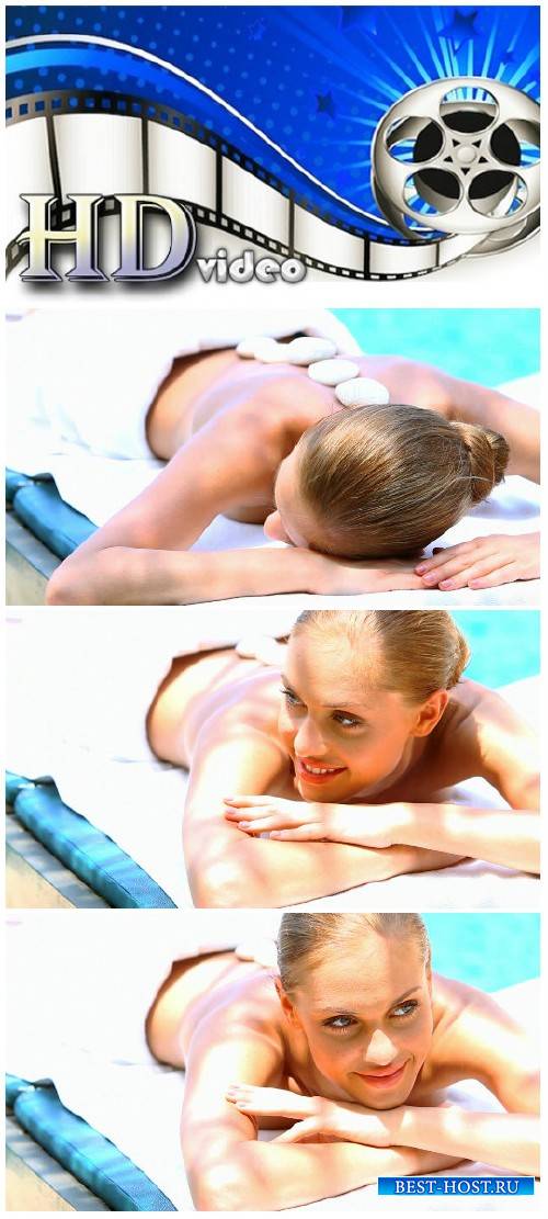 Video footage Woman taking hot stones massage in tropical outdoor