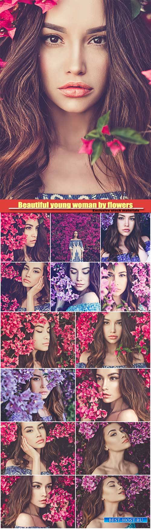 Beautiful young woman surrounded by flowers
