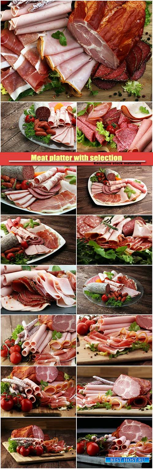 Meat platter with selection, salami, pieces of sliced ham, sausage, tomatoe ...