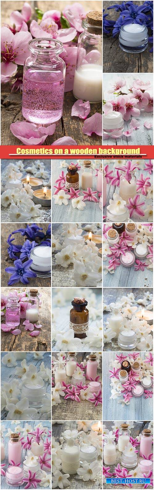 Cosmetics on a wooden background with spring flowers