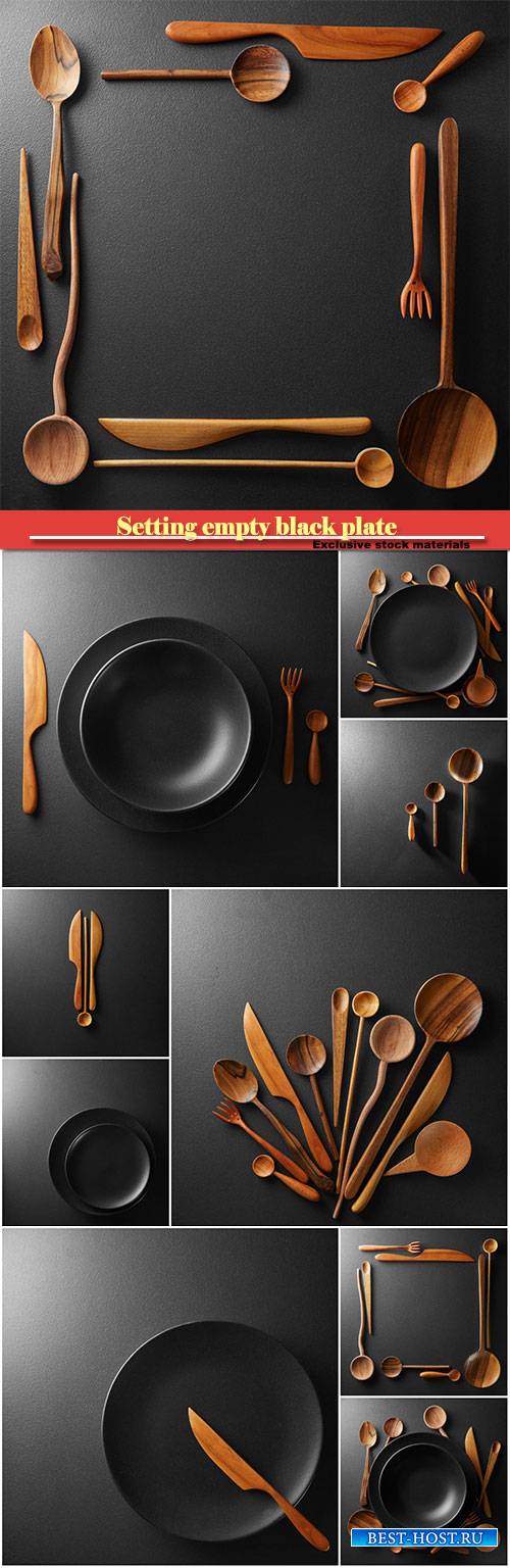 Setting empty black plate and wooden spoon, fork, knife on a black table