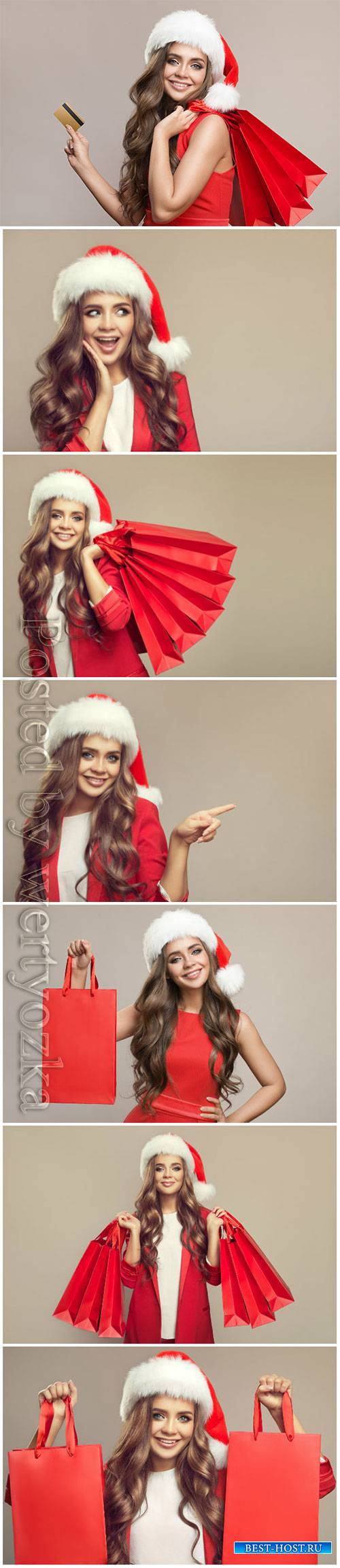 Woman, santa hat, holding, red, shopping, bags